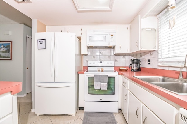 7812 Turnbridge Dr, Port Richey, FL 34668 - kitchen with white appliances, a sink, decorative backsplash, and white cabinets