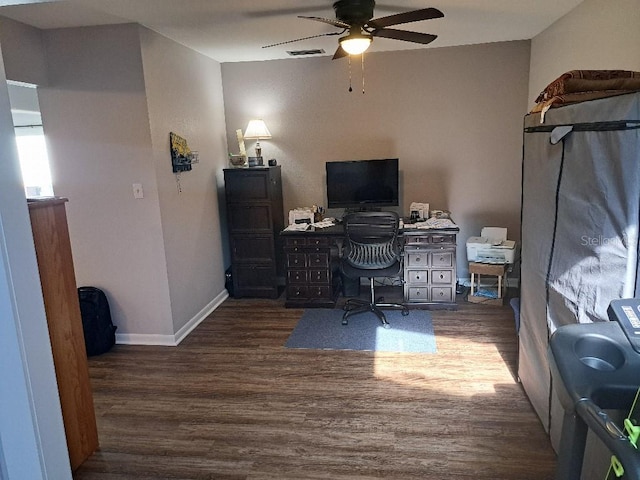 office area with wood finished floors, a ceiling fan, visible vents, and baseboards