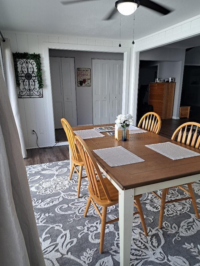dining area with wood finished floors and ceiling fan