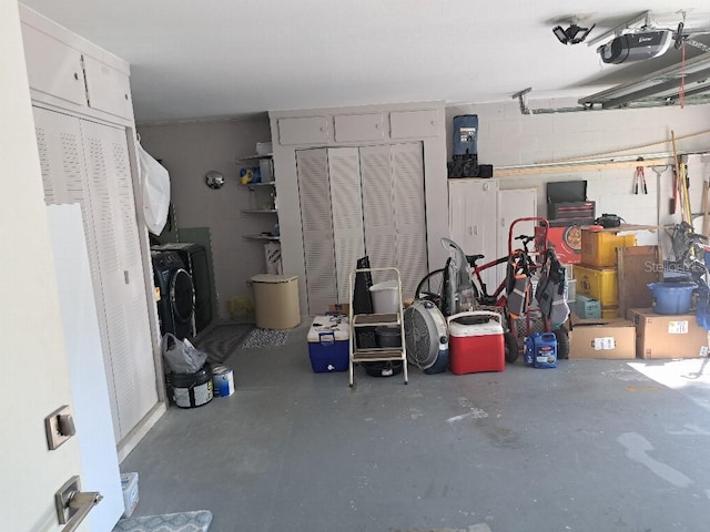 garage featuring washer and dryer and a garage door opener