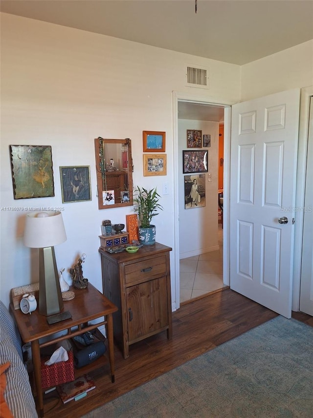 hallway with visible vents and wood finished floors