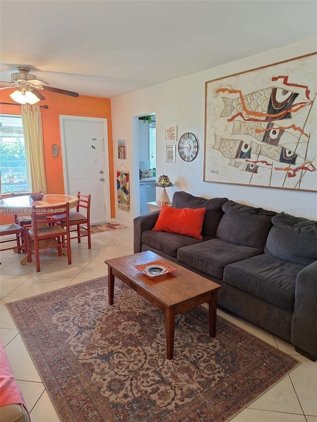 living area featuring ceiling fan and light tile patterned floors