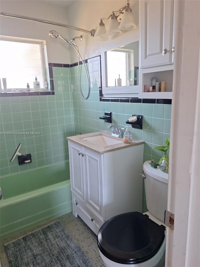 full bathroom featuring vanity,  shower combination, tile walls, toilet, and tile patterned flooring