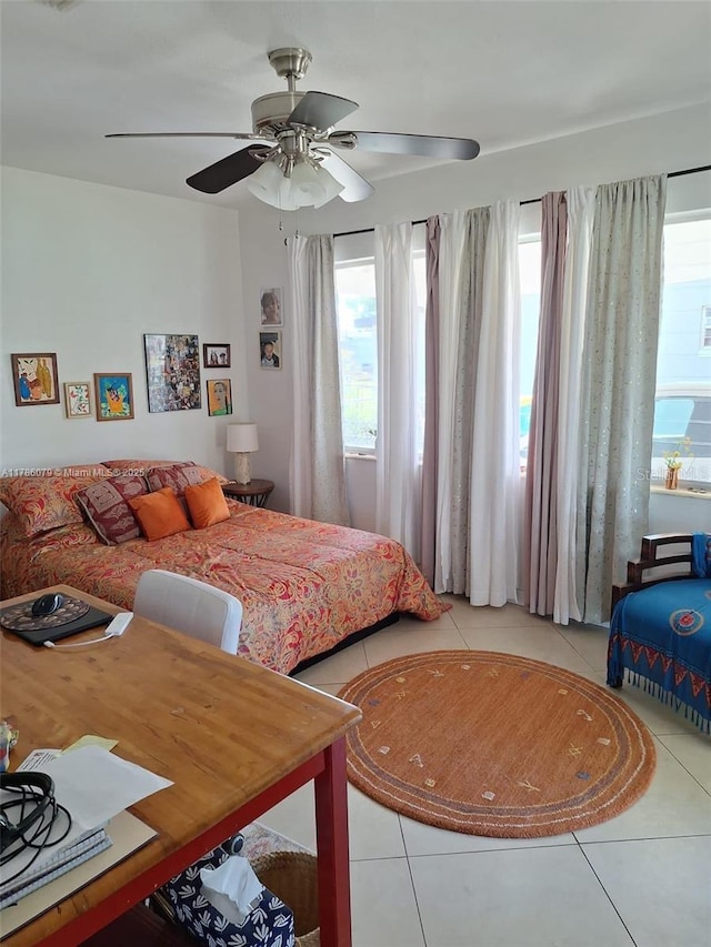 bedroom with ceiling fan and light tile patterned flooring