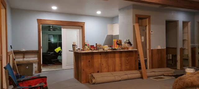 reception area with a ceiling fan and indoor bar