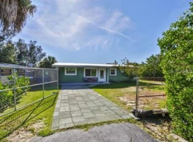 ranch-style house featuring a fenced backyard and a front lawn