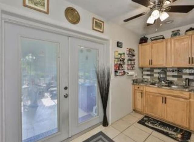 kitchen featuring light brown cabinets, ceiling fan, a sink, and light tile patterned floors