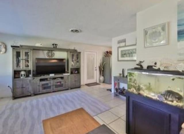 living room with light tile patterned flooring