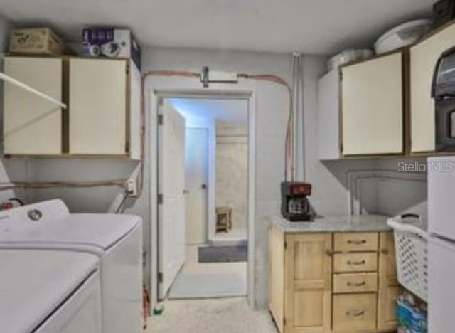 clothes washing area featuring washer and clothes dryer