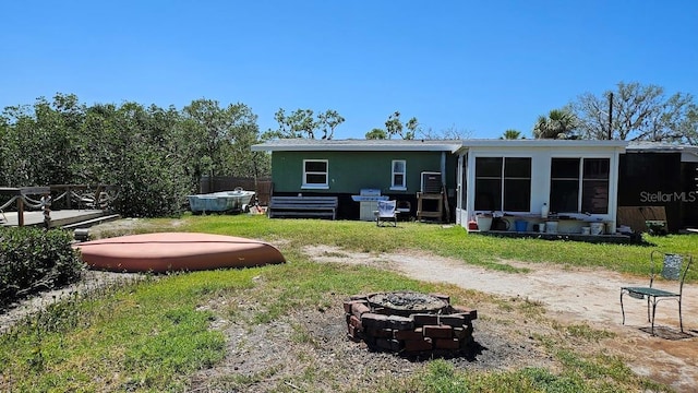 back of house featuring a fire pit
