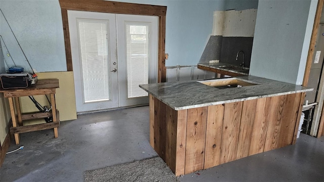 6904 11th Ave E, Palmetto, FL 34221 - kitchen with a sink, concrete flooring, french doors, and a peninsula