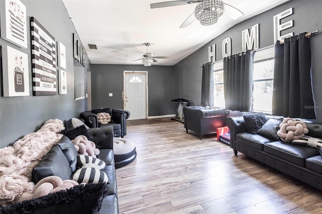 2002 SE Rhode Island St, Arcadia, FL 34266 - living room featuring lofted ceiling, wood finished floors, visible vents, and a ceiling fan