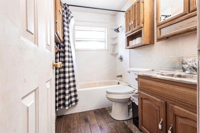 2002 SE Rhode Island St, Arcadia, FL 34266 - full bath with shower / bath combo, backsplash, toilet, vanity, and hardwood / wood-style flooring