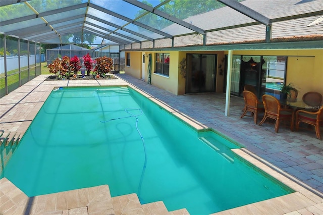 pool featuring fence, a lanai, and a patio area