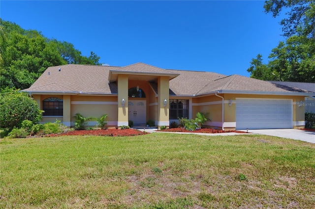 single story home featuring a garage, driveway, a front yard, and stucco siding