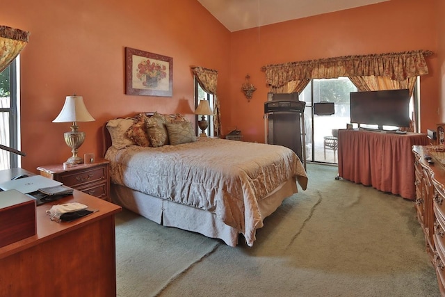 carpeted bedroom featuring multiple windows, access to exterior, and lofted ceiling