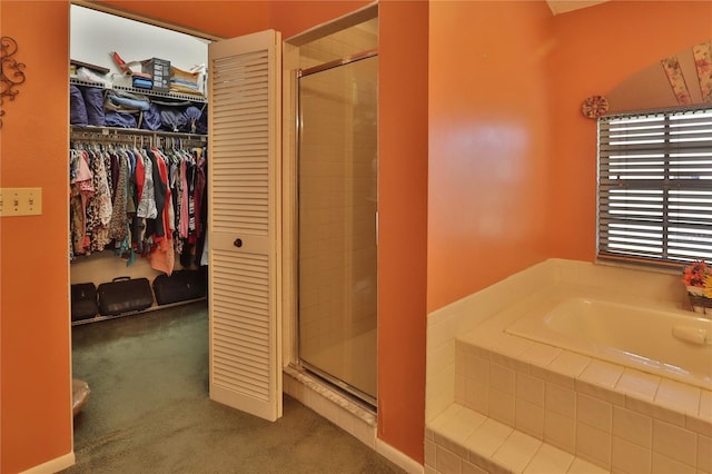 full bath with a bath, a walk in closet, and a stall shower