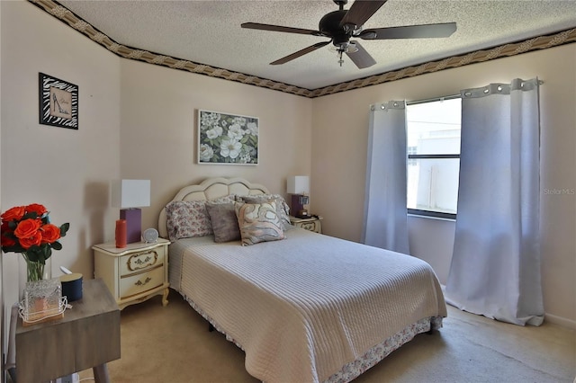 bedroom featuring carpet floors, a ceiling fan, and a textured ceiling