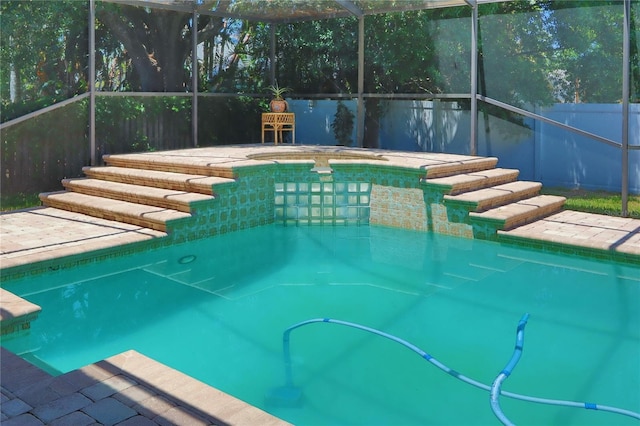 view of pool with a fenced in pool, fence, glass enclosure, and a hot tub