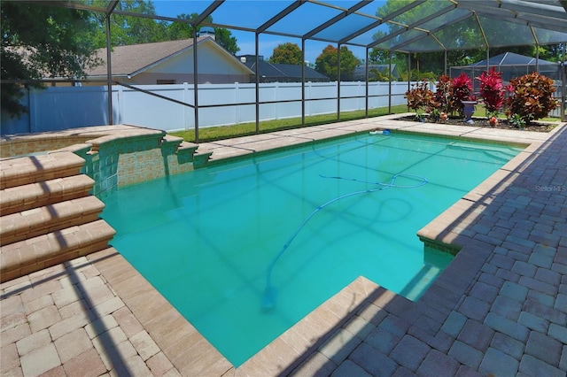 view of pool with a fenced in pool, fence, glass enclosure, and a patio