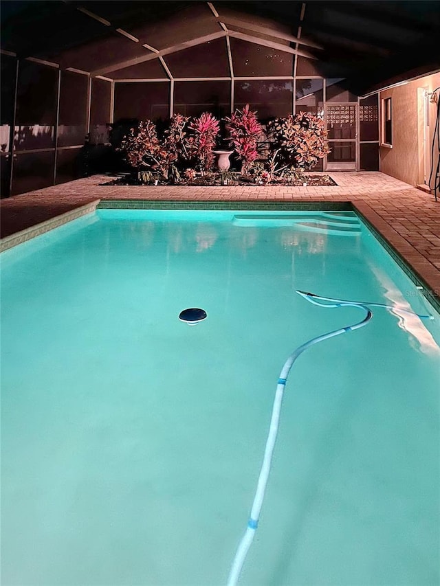 outdoor pool featuring a lanai and a patio area