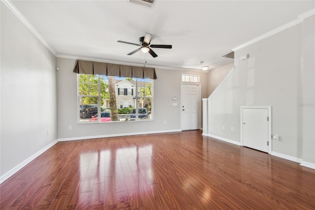 unfurnished living room with crown molding, ceiling fan, visible vents, baseboards, and wood finished floors