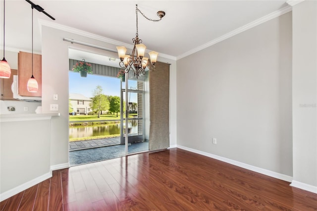 unfurnished dining area featuring wood finished floors, crown molding, a notable chandelier, and baseboards