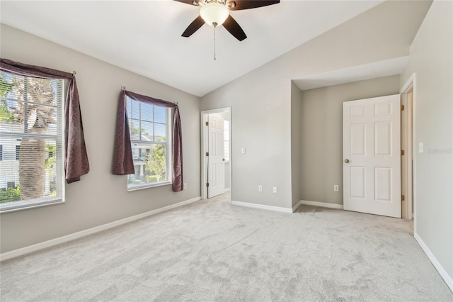 unfurnished room featuring a ceiling fan, baseboards, lofted ceiling, and carpet floors