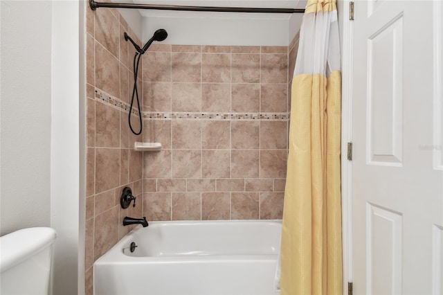 bathroom featuring toilet and shower / bath combination with curtain