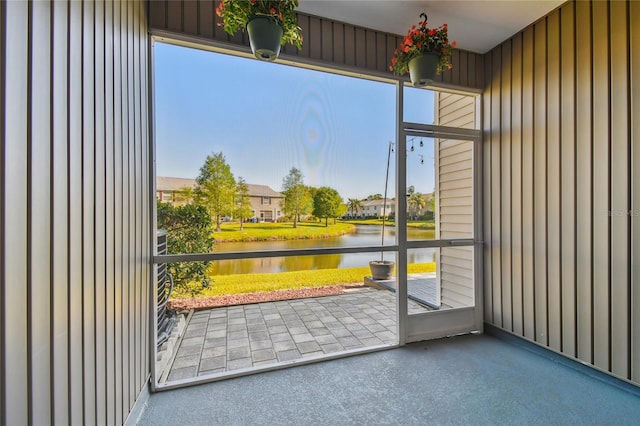 unfurnished sunroom with a wealth of natural light and a water view
