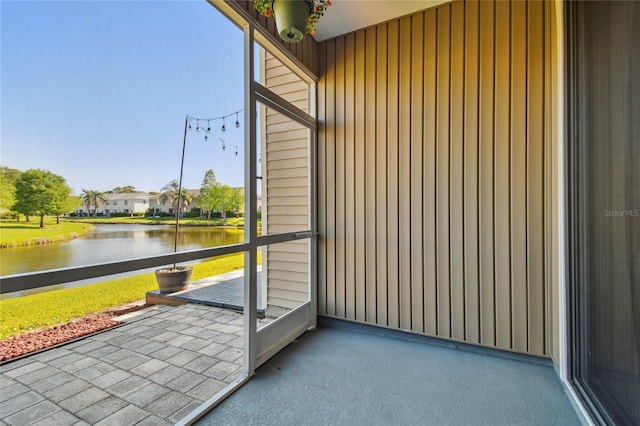 unfurnished sunroom with a water view