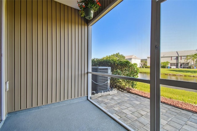 unfurnished sunroom with a water view
