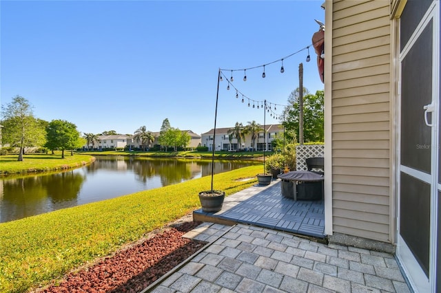 view of patio with a residential view and a water view