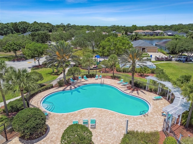 community pool featuring fence and a patio