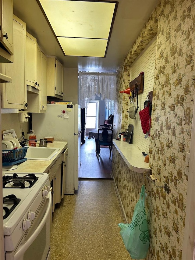 5940 21st St N Unit 11, Saint Petersburg, FL 33714 - kitchen featuring a sink, light countertops, and white range with gas stovetop