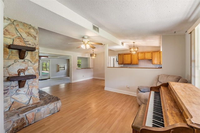15808 Willowdale Rd, Tampa, FL 33625 - living area with a textured ceiling, light wood-style floors, a chandelier, and a ceiling fan
