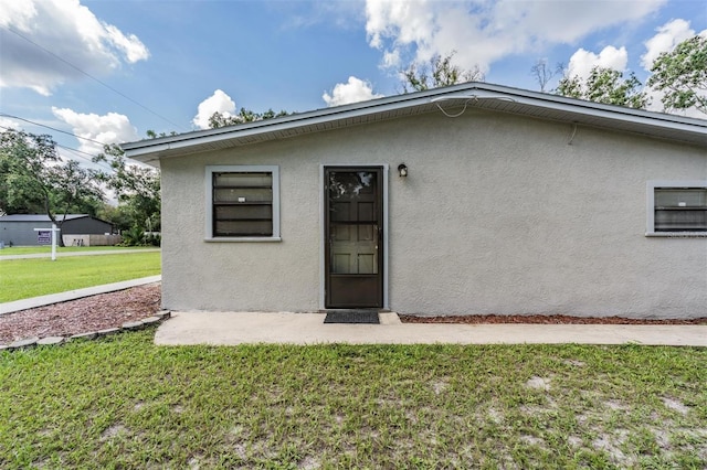 15808 Willowdale Rd, Tampa, FL 33625 - rear view of property featuring stucco siding and a lawn