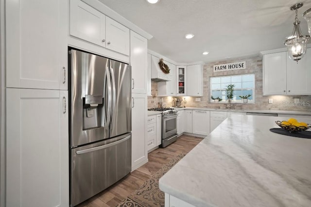 kitchen with recessed lighting, white cabinets, stainless steel appliances, and tasteful backsplash