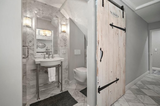 bathroom with a sink, toilet, and marble finish floor