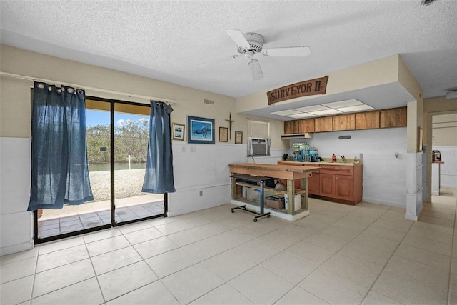 office area with a sink, a ceiling fan, a textured ceiling, and light tile patterned flooring