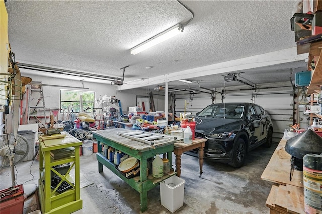 garage with a workshop area and a garage door opener