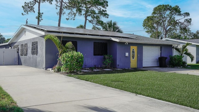4511 Huntington St NE, Saint Petersburg, FL 33703 - ranch-style home with concrete driveway, stucco siding, an attached garage, and roof mounted solar panels