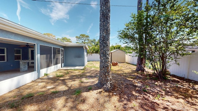 4511 Huntington St NE, Saint Petersburg, FL 33703 - fenced backyard with a sunroom, a storage unit, and ceiling fan