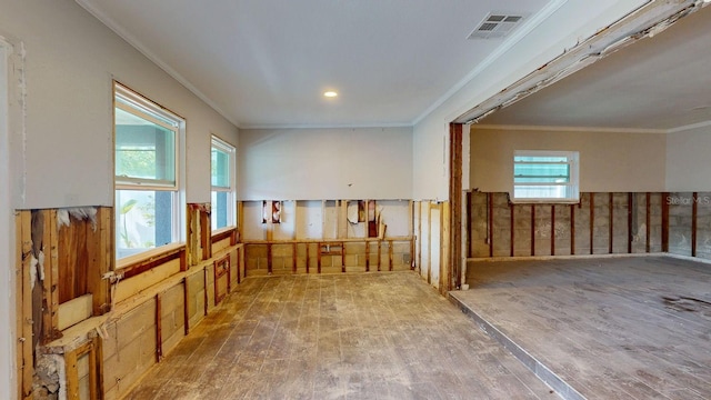 4511 Huntington St NE, Saint Petersburg, FL 33703 - empty room featuring hardwood / wood-style flooring, ornamental molding, and a wainscoted wall