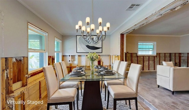 4511 Huntington St NE, Saint Petersburg, FL 33703 - dining room with wood finished floors, a chandelier, and crown molding