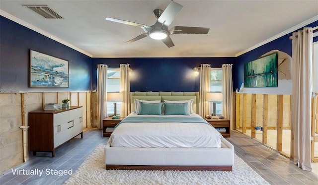 4511 Huntington St NE, Saint Petersburg, FL 33703 - bedroom featuring wood finished floors, crown molding, wainscoting, and ceiling fan