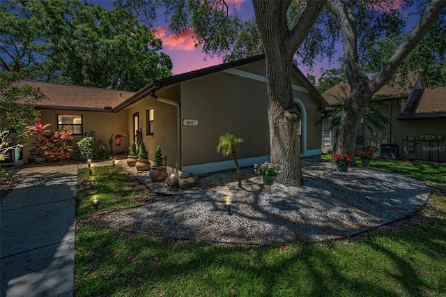 ranch-style house featuring stucco siding