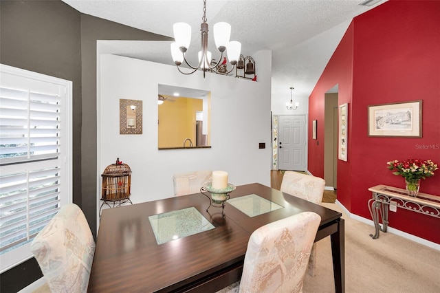 dining space featuring a notable chandelier, carpet floors, a textured ceiling, baseboards, and lofted ceiling