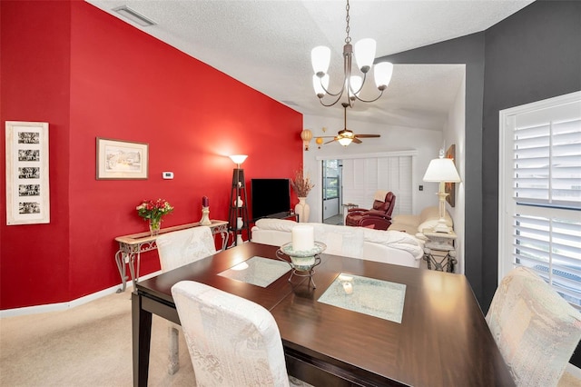 carpeted dining area with baseboards, visible vents, lofted ceiling, and ceiling fan with notable chandelier