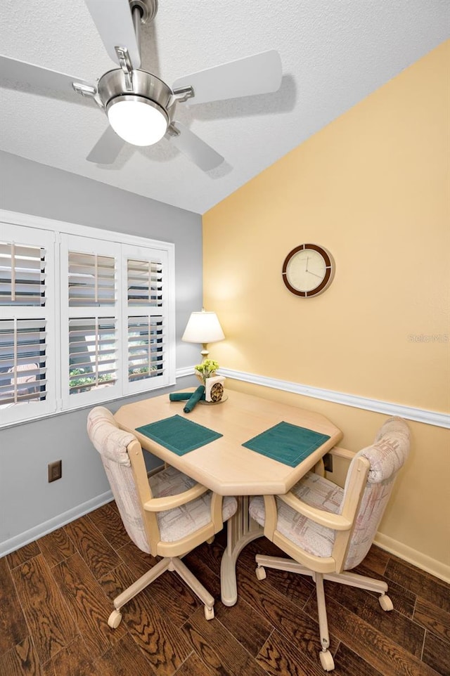 dining space with a ceiling fan, baseboards, and wood finished floors